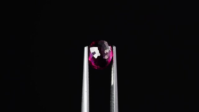 natural red rhodolite gemstone on the turning table