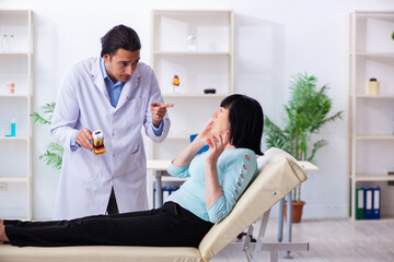 Obraz premium Old woman visiting young doctor dentist