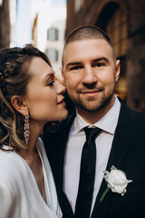 Walking the bride and groom in the fresh air. Facial portrait of a guy and a girl. Warm embrace.