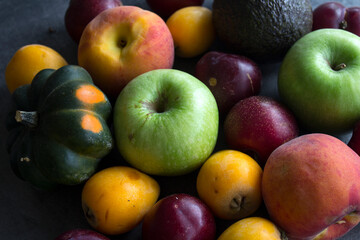 Fresh seasonal fruits and vegetables close up photo. Vibrant colors of raw ingredients. Healthy eating concept. 