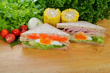 sandwich with ham on wood background