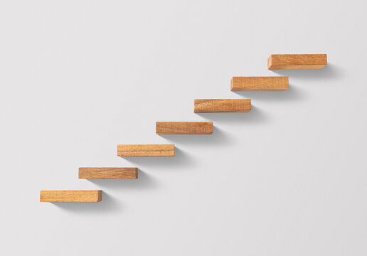 Business growth, business success or career path success concept. Wooden blocks arranged in a shape of staircase on white background.