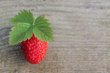 strawberry with leaf on a wooden background