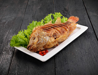 Fried Tilapia fish fried isolated on black background