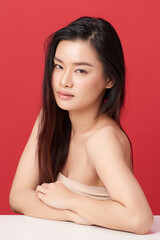 Beautiful young asian woman with clean fresh skin on red background, Face care, Facial treatment, Cosmetology, beauty and spa, Asian women portrait