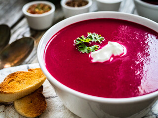 Beetroots cream soup on wooden table
