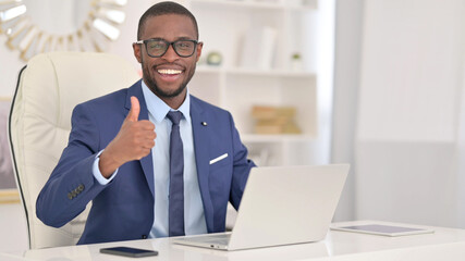 Positive African Businessman with Laptop showing Thumbs Up 