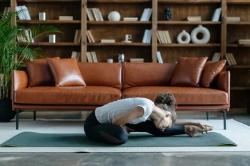 Gordijnen Young african american woman doing yoga training at home © brizmaker
