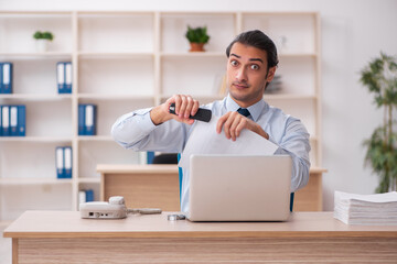 Young male employee working in the office
