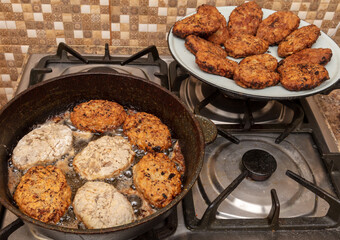 Minced meat cutlets are fried in oil