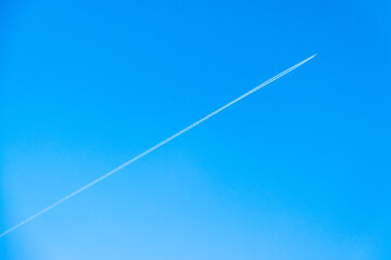 The trail from the plane against the sky.