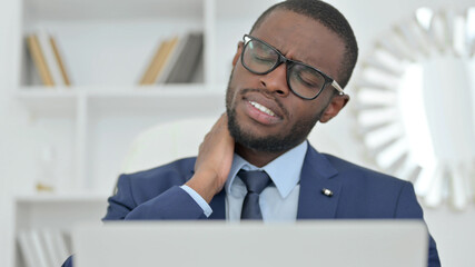 Portrait of African Businessman with Laptop having Neck Pain 