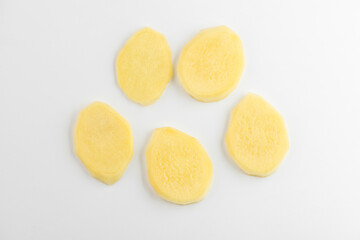 Small portion of slices of a ginger root on white background