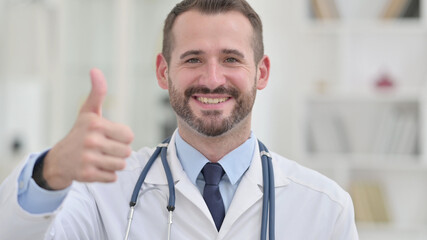 Portrait of Positive Male Doctor showing Thumbs Up 