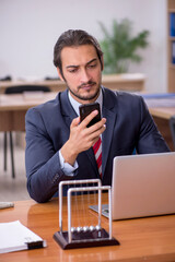 Young man businessman employee sitting in the office