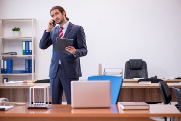 Fototapeta premium Young man businessman employee sitting in the office