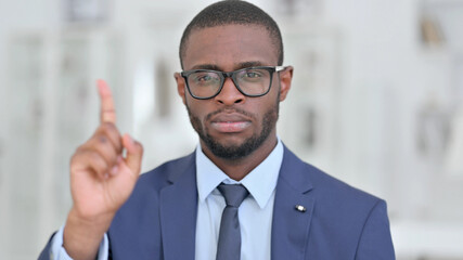 Portrait of African Businessman saying No by Finger Sign 