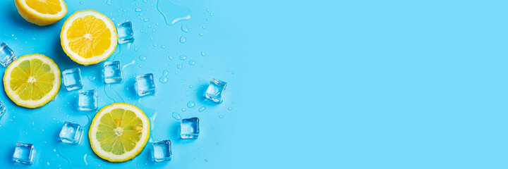juicy fresh yellow lemon slices and ice cubes on a blue background. Top view, flat lay. Banner