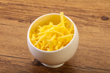 Shredded yellow cheese in the bowl