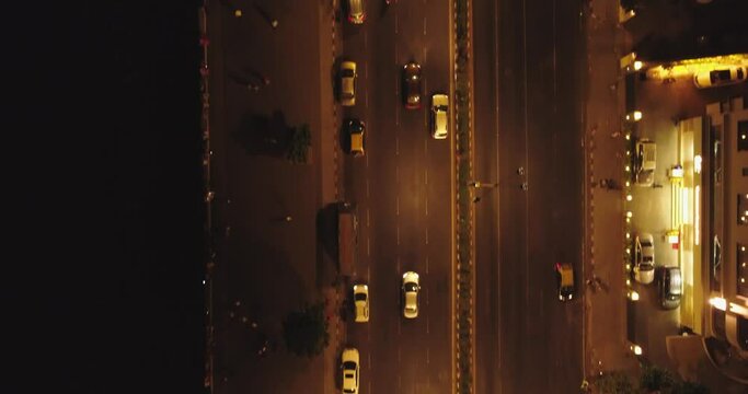 An aerial view with cinematic drone movement of the iconic Marine Drive nightlife with Air India and Trident Hotel buildings in sight.