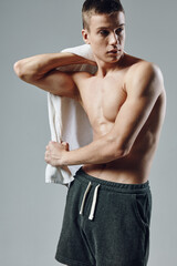 sporty man wipes sweat after workout with towel cropped view