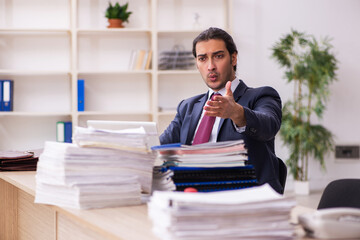 Young male employee unhappy with excessive work