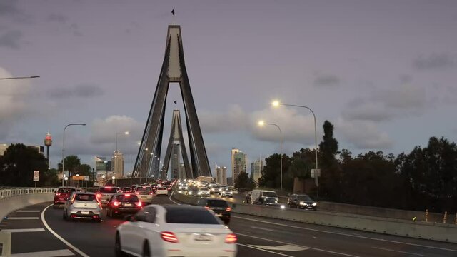Fast traffic on Anzac birdge in Sydney at sunset &ndash; illumination and CBD 4k.
