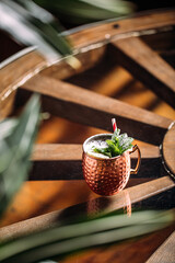 Copper mug of fresh cocktail with mint and powdered sugar