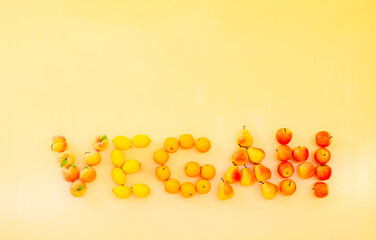 VEGAN word made from fresh fruits (peach, lemon, orange, pear, apple)