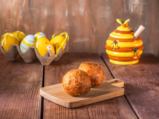 Easter card with blooming willow and yellow painted eggs on a crone stand, balls of sand cakes
