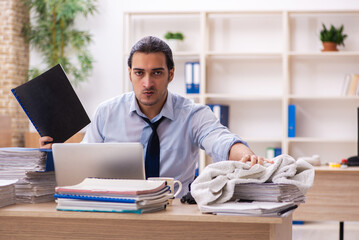 Young male employee sweating at workplace