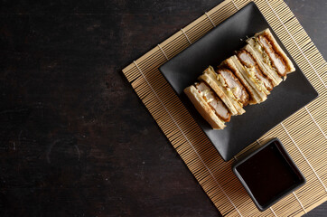 Katsu sandos japanese sandwich with chicken or pork chop, cabbage and tonkatsu sauce.