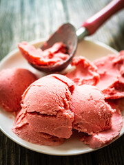 Strawberry ice cream with fresh fruits on wooden background
