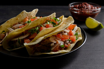 Mexican birria tacos, quesabirria with lime and chili sauce