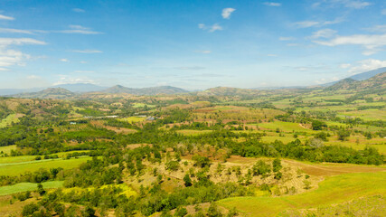 Fototapeta na wymiar Aerial drone of Agricultural land with sown green fields in countryside. Mindanao, Philippines.