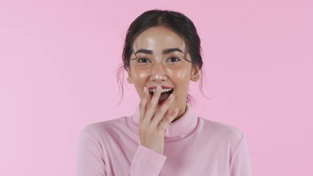 Beauty concept of 4k Resolution. Young Asian woman rejoicing on the pink background.