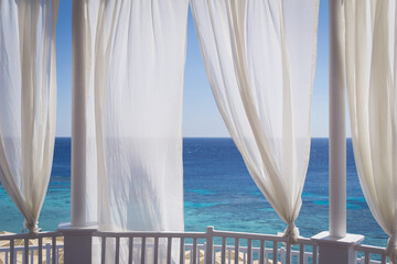 Romantic gazebo on the beach with blue sea