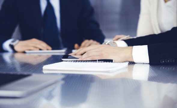 Business People Working Together At Meeting In A Modern Office. Unknown Businessman And Woman With Colleagues Or Lawyers At Negotiation About Contract