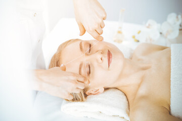 Obraz na płótnie Canvas Blonde woman getting face depilation procedure. Beauty and Spa salon concept