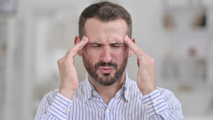 Obraz premium Portrait of Tired Young Man having Headache