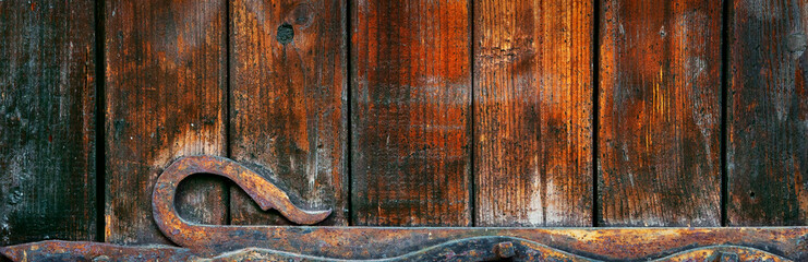 Forged metal elements on wooden doors. Background and texture.