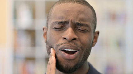 Close up of Young African Man having Toothache