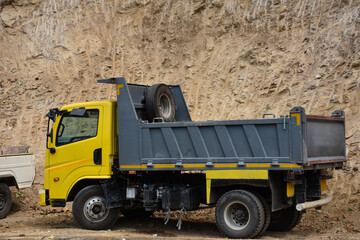 Truck with yellow cabin with grey body