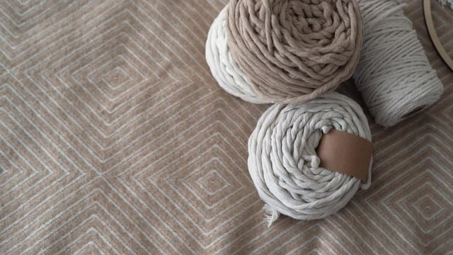 rope for macrame, Weaving macrame. Balls of twine for weaving are thrown onto the bed. Copy space.