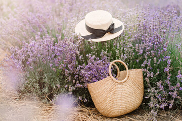Wicker basket with a fresh cut lavender and hat in the field.