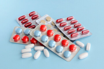 Pharmaceutical medicine pills over blue background