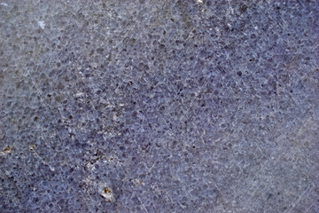 Blue marble surface close-up with flecks and cracks