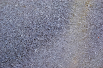 Blue marble surface close-up with flecks and cracks