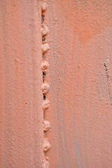 The metal surface painted with multicolored colors speckles and stripes is sloppy