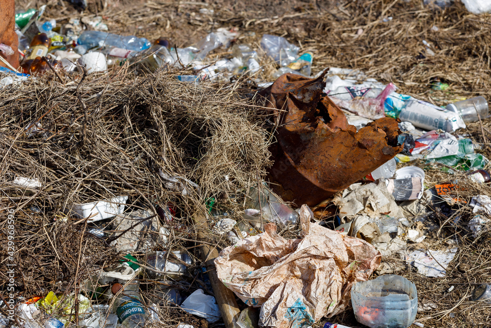 Poster garbage lying on the grass. pollution